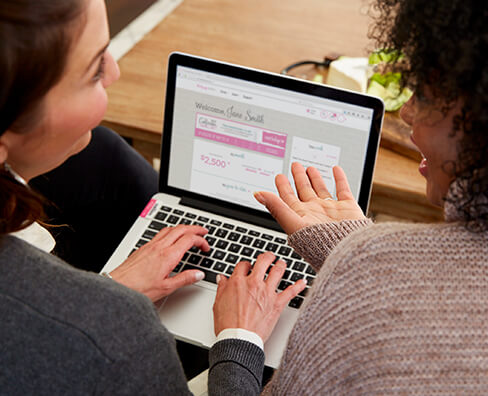 two women looking at a catalog